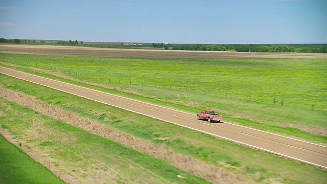 在美国堪萨斯州Trego县的乡村公路上行驶的泥泞红色皮卡视频下载
