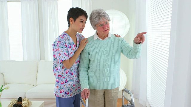 亚洲护士和老年病人望着窗外视频下载