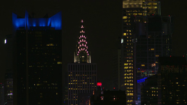 夜间的克莱斯勒大厦被其他摩天大楼包围着。视频素材