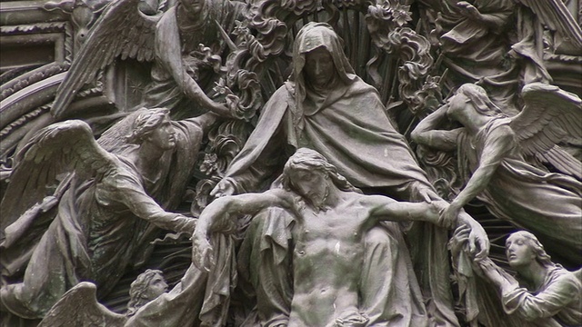 米兰大教堂的墙上雕刻着天使抱着基督的身体的宗教场景。高清。视频下载