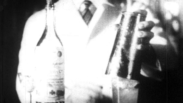 20世纪20年代的近距离调酒师使用摇酒器/酒瓶在前景/新闻胶片视频素材