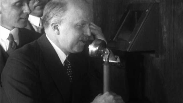 1927年，一个人(威廉S.吉福德?)在电话上说话+在盒子里寻找试验电视视频素材