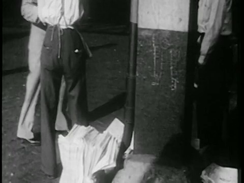 1939年后景卖报纸的报童+城市人行道上的路人/纽约/纪录片视频素材