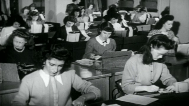 1950年，一排排妇女在办公桌前用打卡机打字视频下载