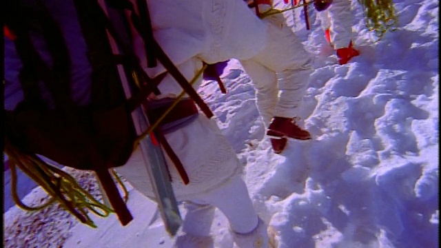 特写镜头跟随4名滑雪者爬上多雪的山坡视频下载