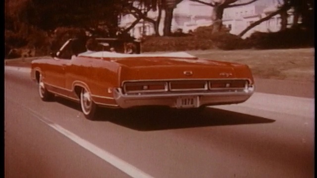 1970年，REAR VIEW跟踪在郊区街道上行驶的红色敞篷车Mercury Marquis视频下载