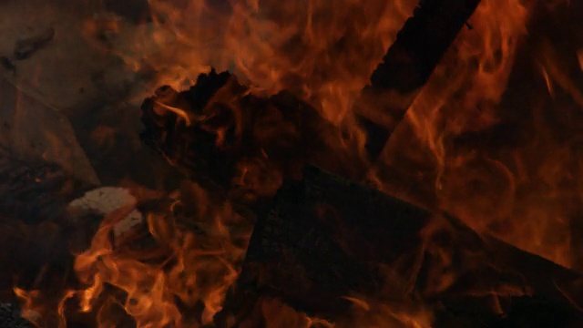 一所被大火烧毁的房屋的横梁被烧焦了，四周都有火焰在燃烧视频素材