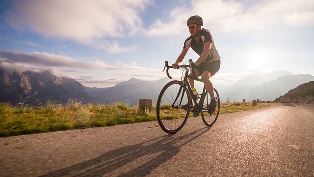 日落时分在山口上骑公路自行车视频素材