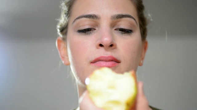 一个女人吃苹果的照片/伦敦，大伦敦，英国视频下载