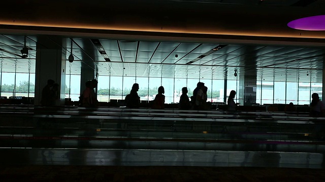 在机场乘坐自动扶梯的乘客剪影。真正的时间。视频下载