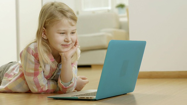 小女孩看着笔记本电脑屏幕视频素材