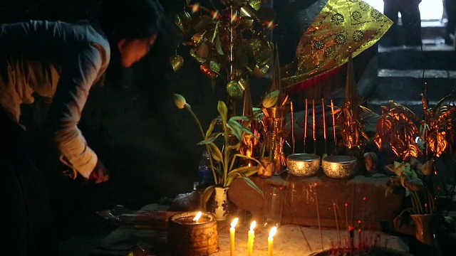 柬埔寨，人们在一座寺庙内点燃蜡烛和熏香视频素材