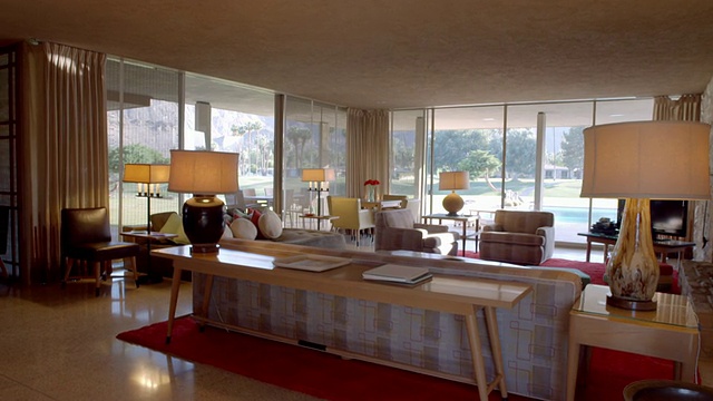 TS穿过20世纪50年代的原始客厅，里面有原始定制的家具和落地窗，可以俯瞰私人乡村俱乐部的高尔夫球场视频素材