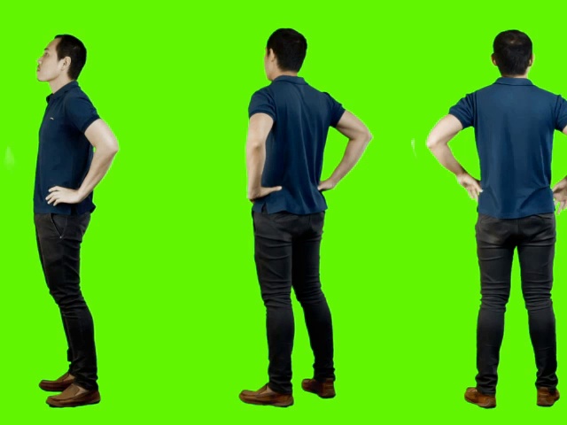 年轻的亚裔男子随意站立，绿色背景。视频素材