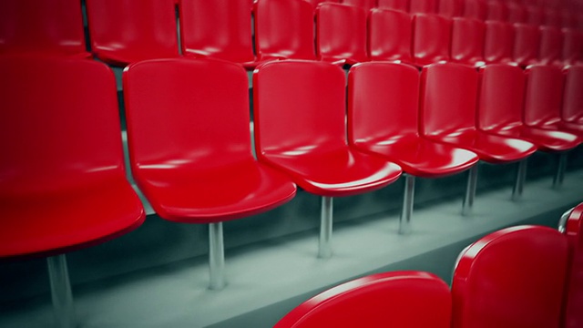 红色的体育场座位排成一排。Loopable。视频素材