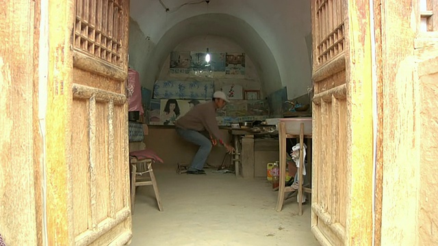 这是中国山西黄河流域窑洞里工作的男子的照片视频下载