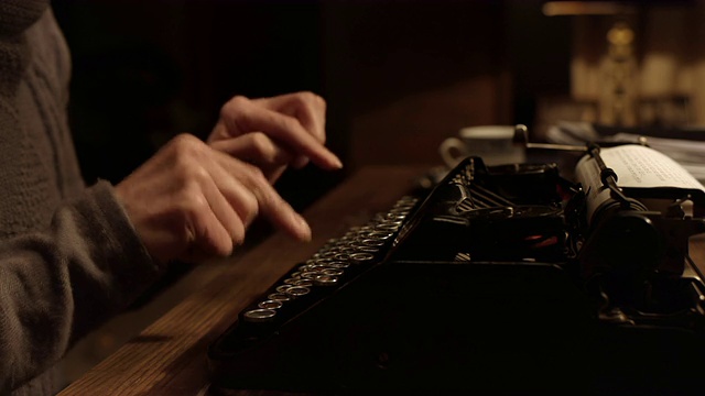 一个女人在旧打字机上按键盘视频素材