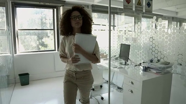 WS steadycam_富有创造力的女商人拿起文件，走到同事的办公室视频素材