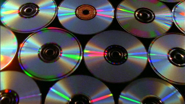 近距离跟踪拍摄在桌子上的一排排cd覆盖着黑色的布视频下载