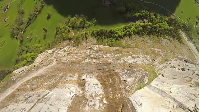 定点跳伞者从悬崖上跳起，在空中做空翻视频下载
