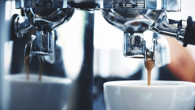 一杯美式咖啡从专业的浓缩咖啡机里倒出来视频素材