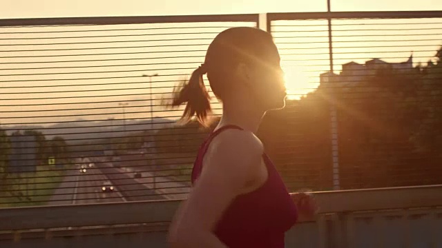 日落时分，一个女人跑过天桥视频素材