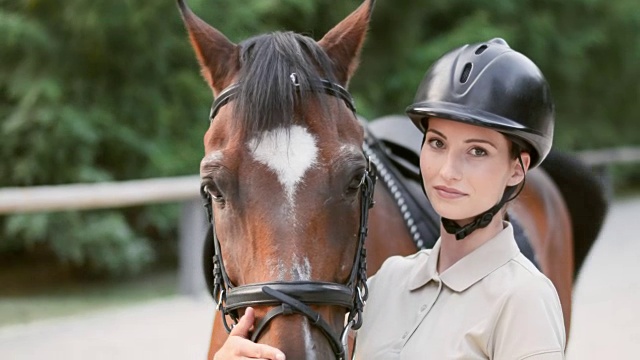 一个女骑手和她的栗色马的肖像视频下载