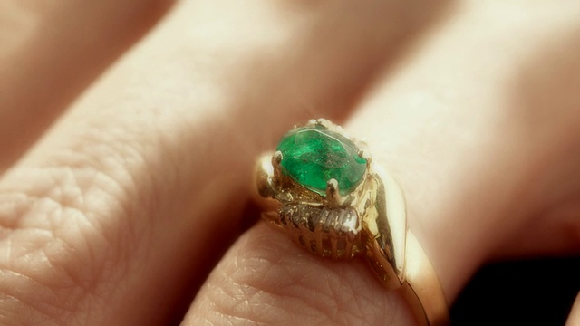 ECU PAN横跨手指，戴着镶有绿宝石的镶钻金戒指/美国加州洛杉矶视频素材