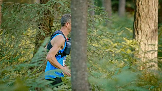 SLO MO DS一名男子跑马拉松穿过森林视频下载