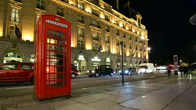 图片拍摄于皮卡迪利大街上的传统红色电话亭，里面是丽兹酒店，乘客和交通都很快。/大伦敦，英国视频素材