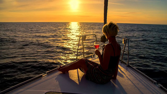 LS女人在日落航行时喝酒视频素材