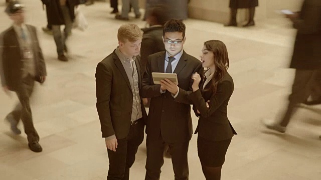 一群年轻的多样化的商业专业人士在一起讨论数字平板电脑视频素材