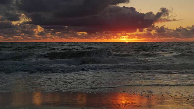 橙色的太阳升起在大西洋的地平线上，戏剧性的云和颜色视频素材