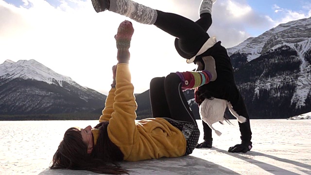 两个女杂技演员在雪地里表演动作视频素材