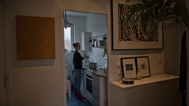 一个迷人的年轻女子在她的新公寓厨房洗盘子视频素材