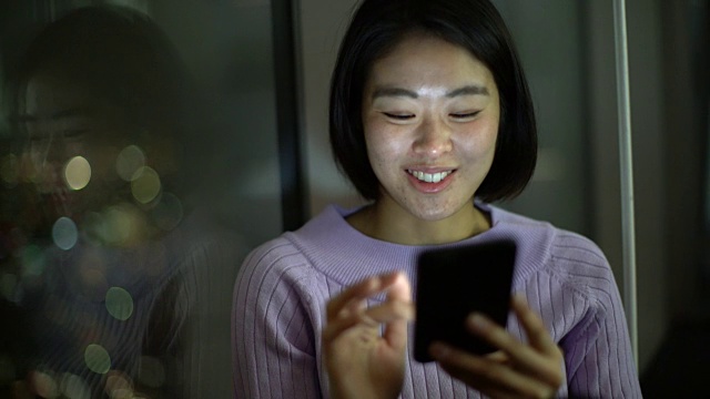 年轻女子坐在窗口边发短信视频购买
