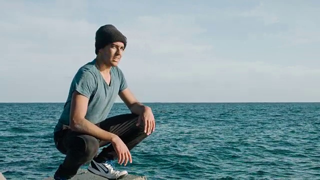 年轻的男性在自由奔跑后在海边放松视频素材