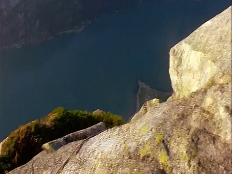 穿着连体服的男性定点跳伞运动员行走+跳下悬崖/瑞典视频素材