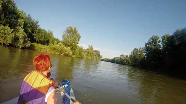 年轻女子在河上划皮艇视频素材
