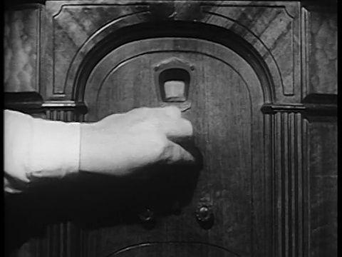 B/W 20世纪30年代/40年代靠近男人的手转动旋钮收音机视频素材