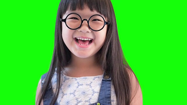 小女孩在绿色的屏幕上笑视频素材