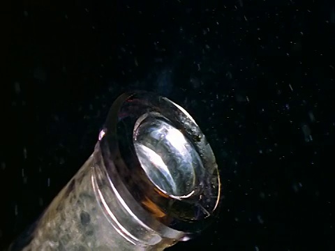 慢镜头极端接近潘软木塞被移出酒瓶与黑色背景视频素材