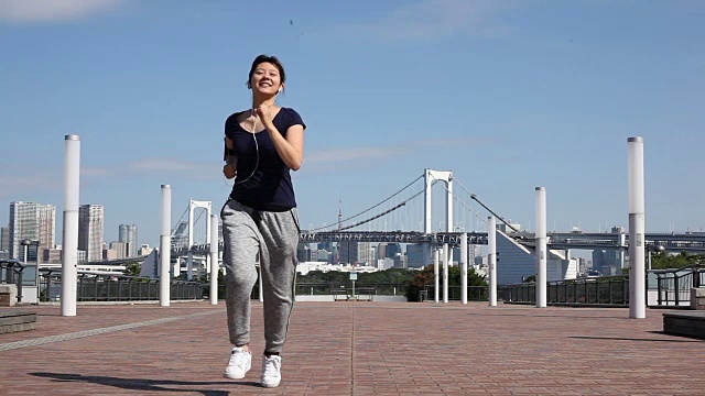 一名日本妇女在公园里慢跑视频素材