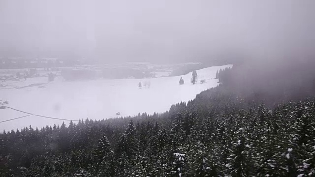 雾在慢慢地移动，覆盖着雪山。视频下载