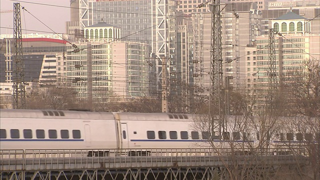 一列子弹头列车经过北京的高楼大厦。视频素材