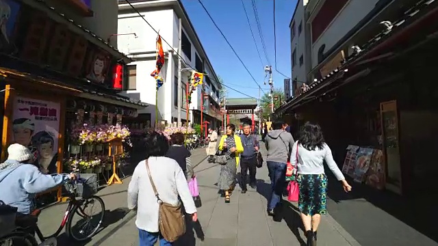 在东京浅草的奥山Omairimachi商业街，行走的相机正在穿行。相机捕捉到了沿街的传统日本礼品店、餐馆和公共剧院。视频素材