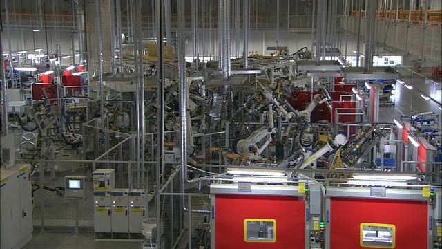 自动化机器在汽车工厂中运行。视频素材