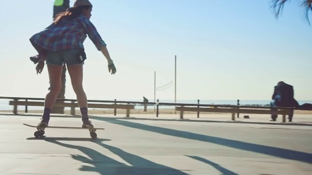 在海滩玩滑板的女人视频下载