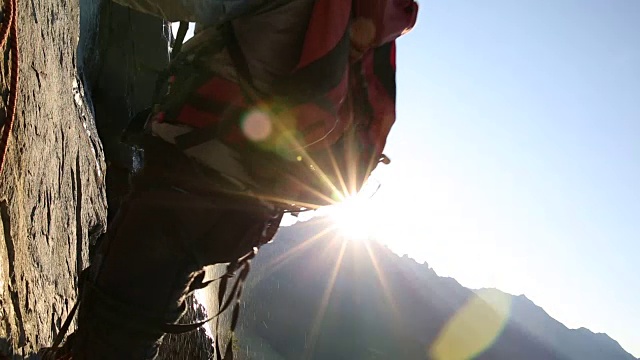 登山运动员攀登岩壁，日出视频素材