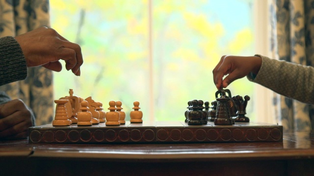 南非西开普省开普敦，一名非洲男子与孙辈下棋视频下载